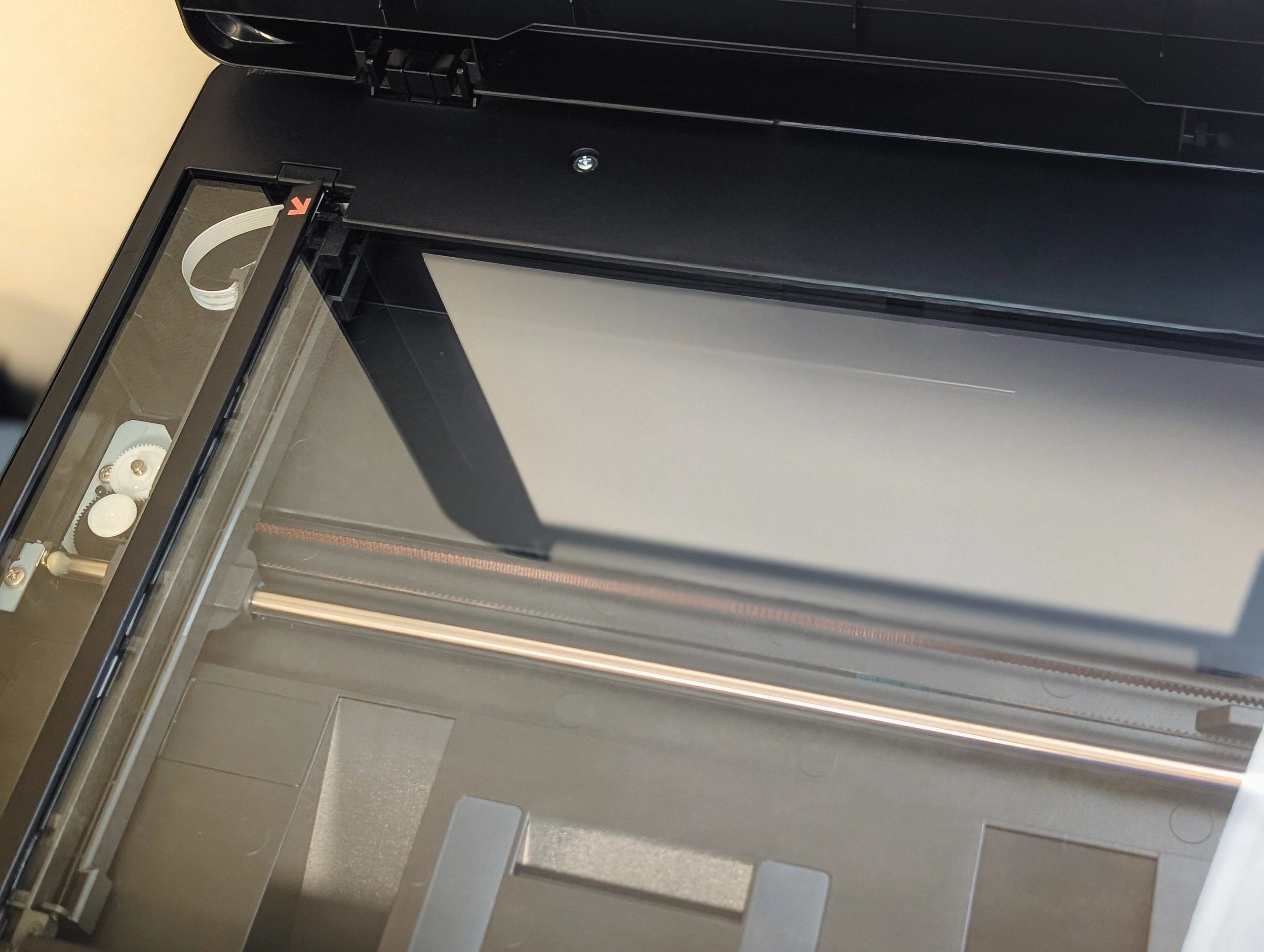 overhead view of the empty glass flatbed surface of a multi-function printer scanner